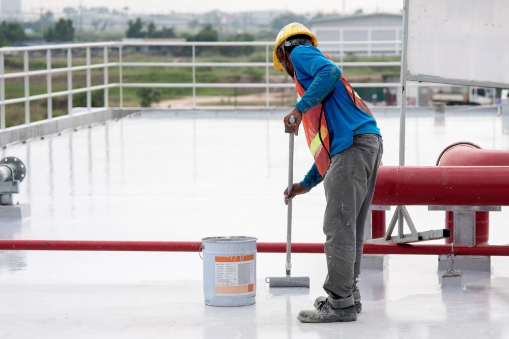 construction-worker-coating-epoxy-paint-roof-slab-water-proof-protection-1