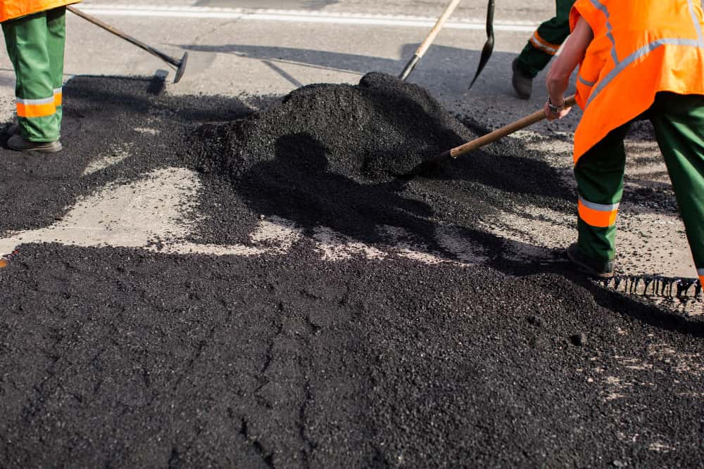 workers-asphalting-paver-machine-during-road-street-repairing-works-1